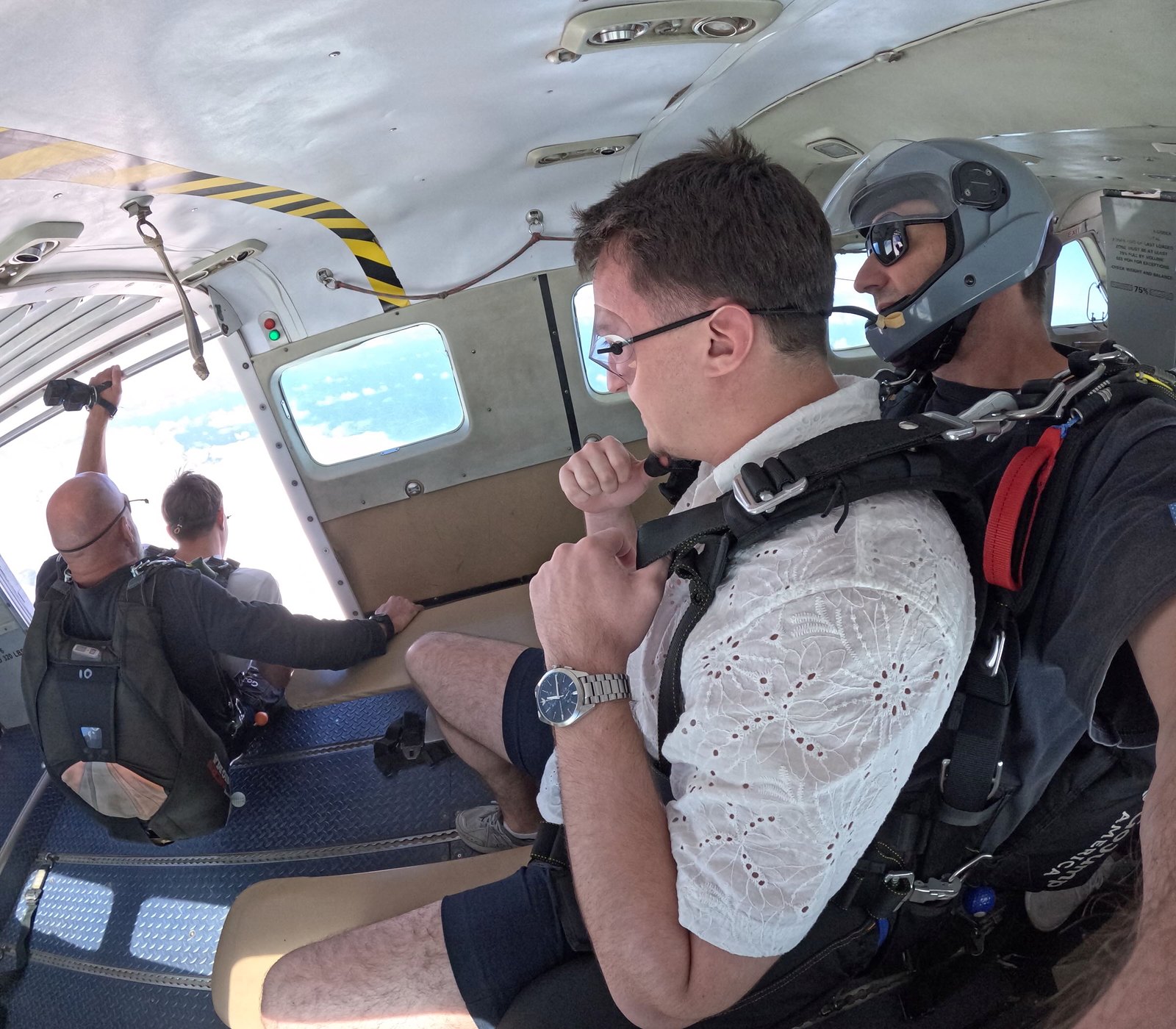 Uranik wearing a tandem harness inside the aircraft before a jump.